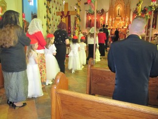 Those being confirmed line up to receive the sacrament